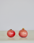 Handcrafted ceramic pomegranate ornament in deep red glaze by Marla Primrose – decorative artisan pottery for home or gift.