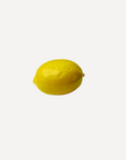 Handmade ceramic lemon with glossy glaze by Marla Primrose – realistic artisan stoneware fruit decor handcrafted in the UK.