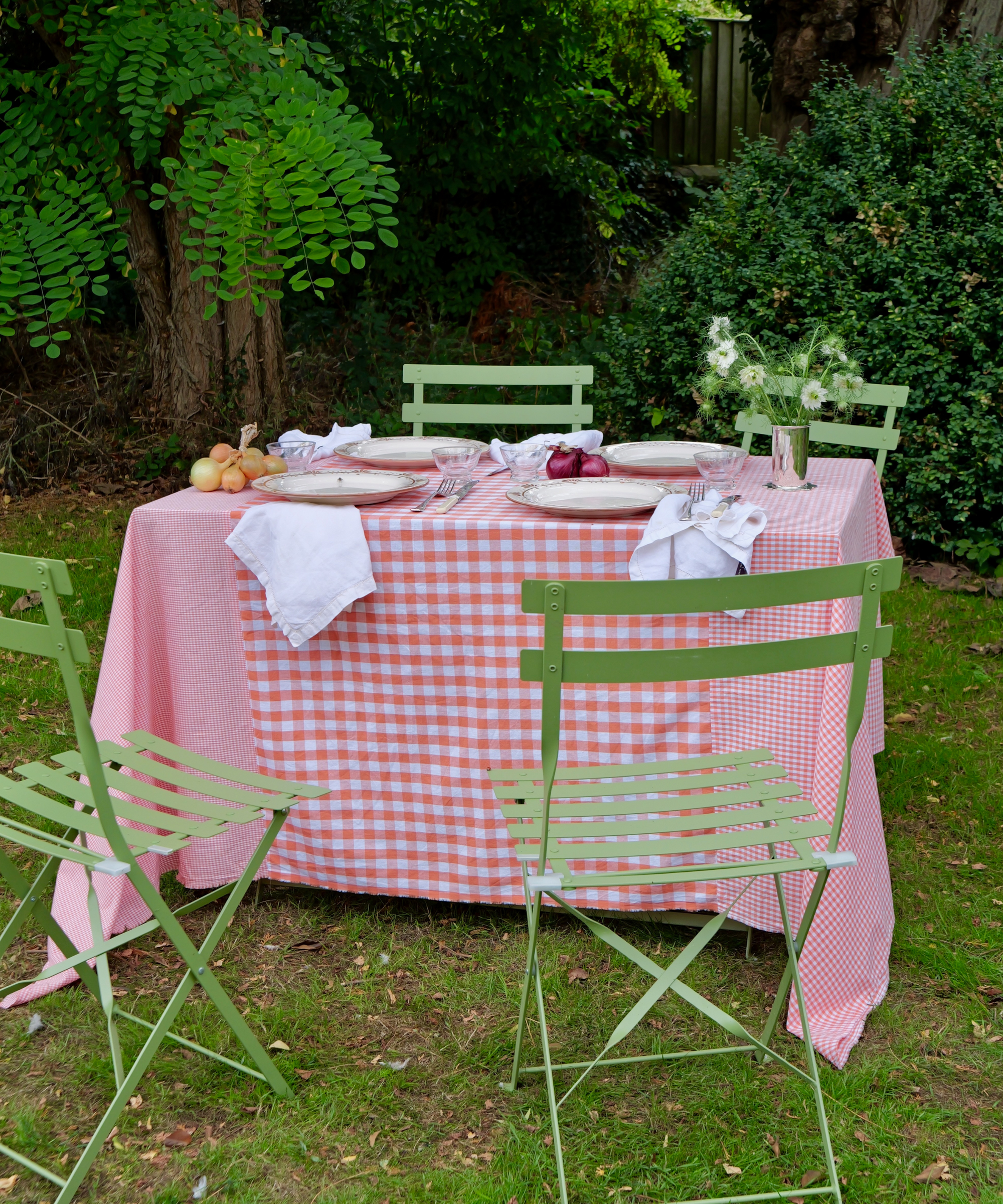 Hand-stitched orange gingham tablecloth with patchwork design on a dining table