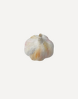 Realistic handmade ceramic garlic by Marla Primrose, crafted in stoneware with a soft matte glaze – a unique touch of rustic charm for any home.