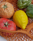 Vibrant handmade ceramic orange by Marla Primrose, crafted in stoneware and finished with a glossy glaze – a unique artisanal home accent.
