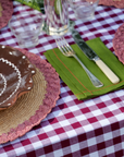 High-quality 100% linen napkin in forest green with red stitch detail, sold individually.