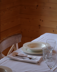 Italian-made white gingham napkin with alpine motifs, designed for mountain chalet style tablescapes.