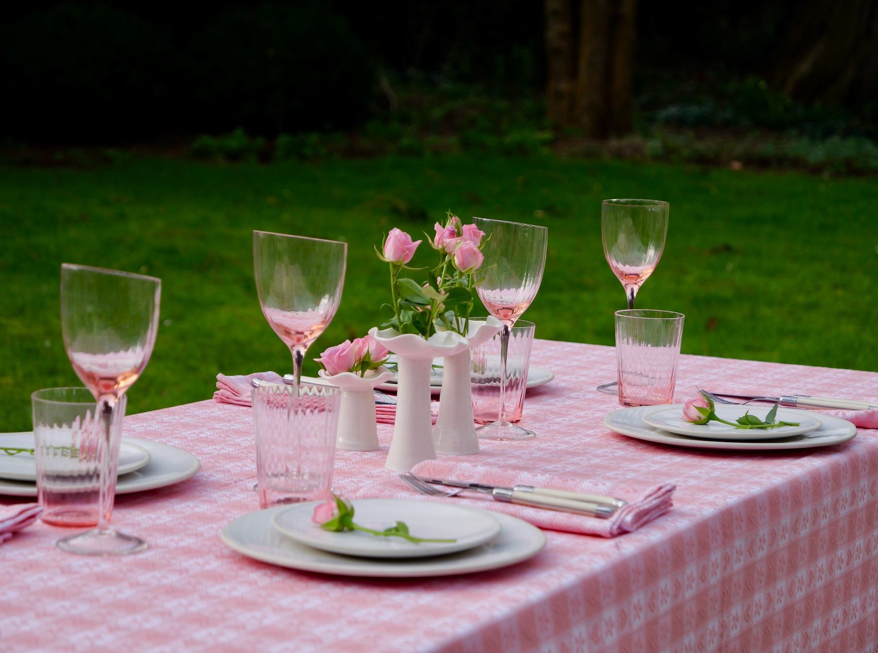 Marla Primrose Alpine Pink Chalet Napkin folded on a rustic wooden table, evoking cozy mountain dining.