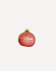 Handcrafted ceramic pomegranate ornament in red glaze by Marla Primrose – decorative artisan pottery for home or gift.