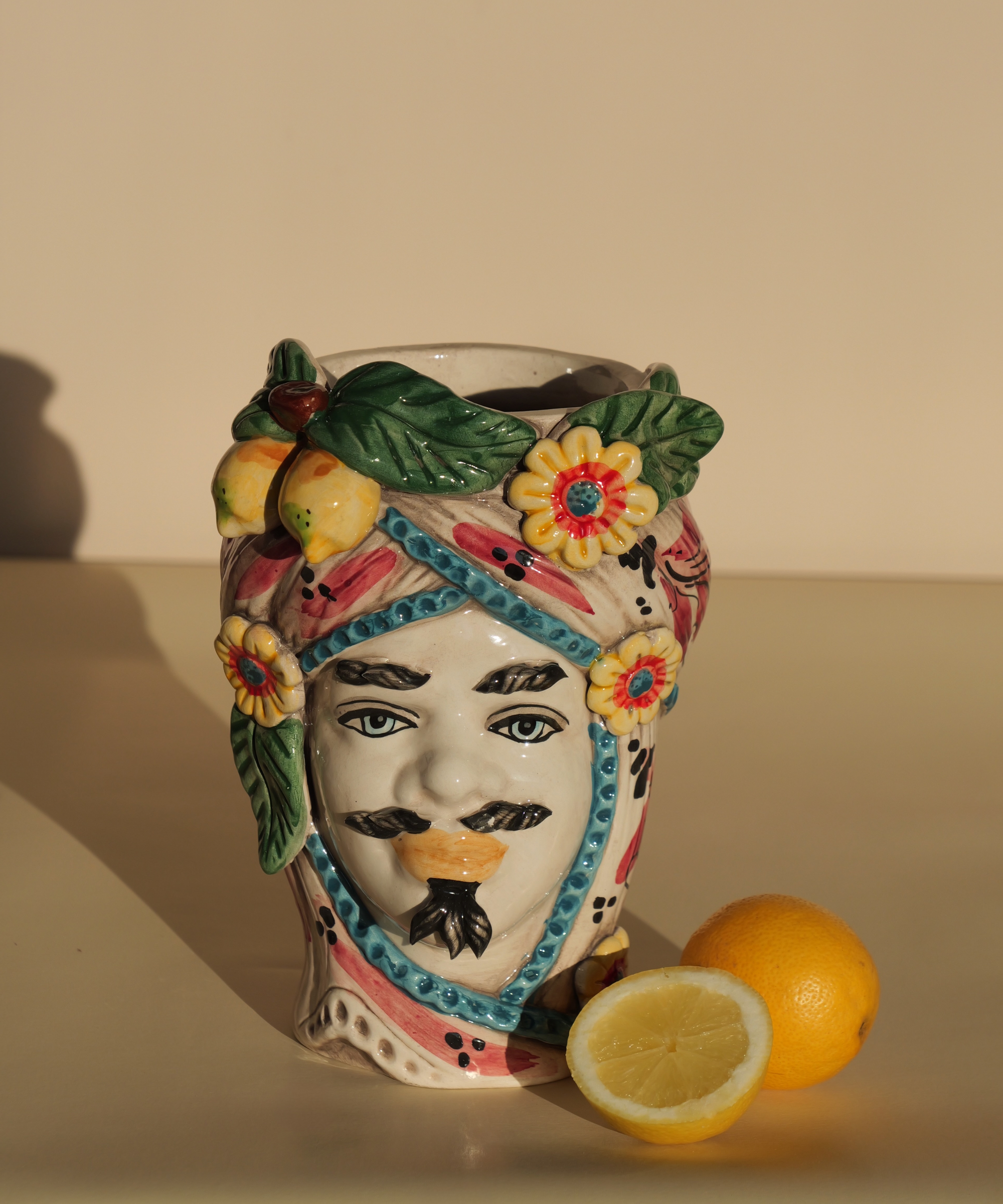 Handmade Sicilian male head vase with lemon and flower crown – ceramic Testa di Moro with Mediterranean detailing.