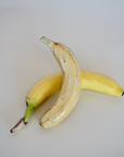 Glossy handmade ceramic banana, crafted in Spain from stoneware – a bold and cheerful artisan accent for your home.