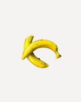 Glossy handmade ceramic banana, crafted in Spain from stoneware – a bold and cheerful artisan accent for your home.