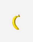 Glossy handmade ceramic banana, crafted in Spain from stoneware – a bold and cheerful artisan accent for your home.