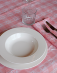 Pink and white gingham chalet napkin with heart and floral motifs, crafted in Italy from Oeko-Tex certified cotton.