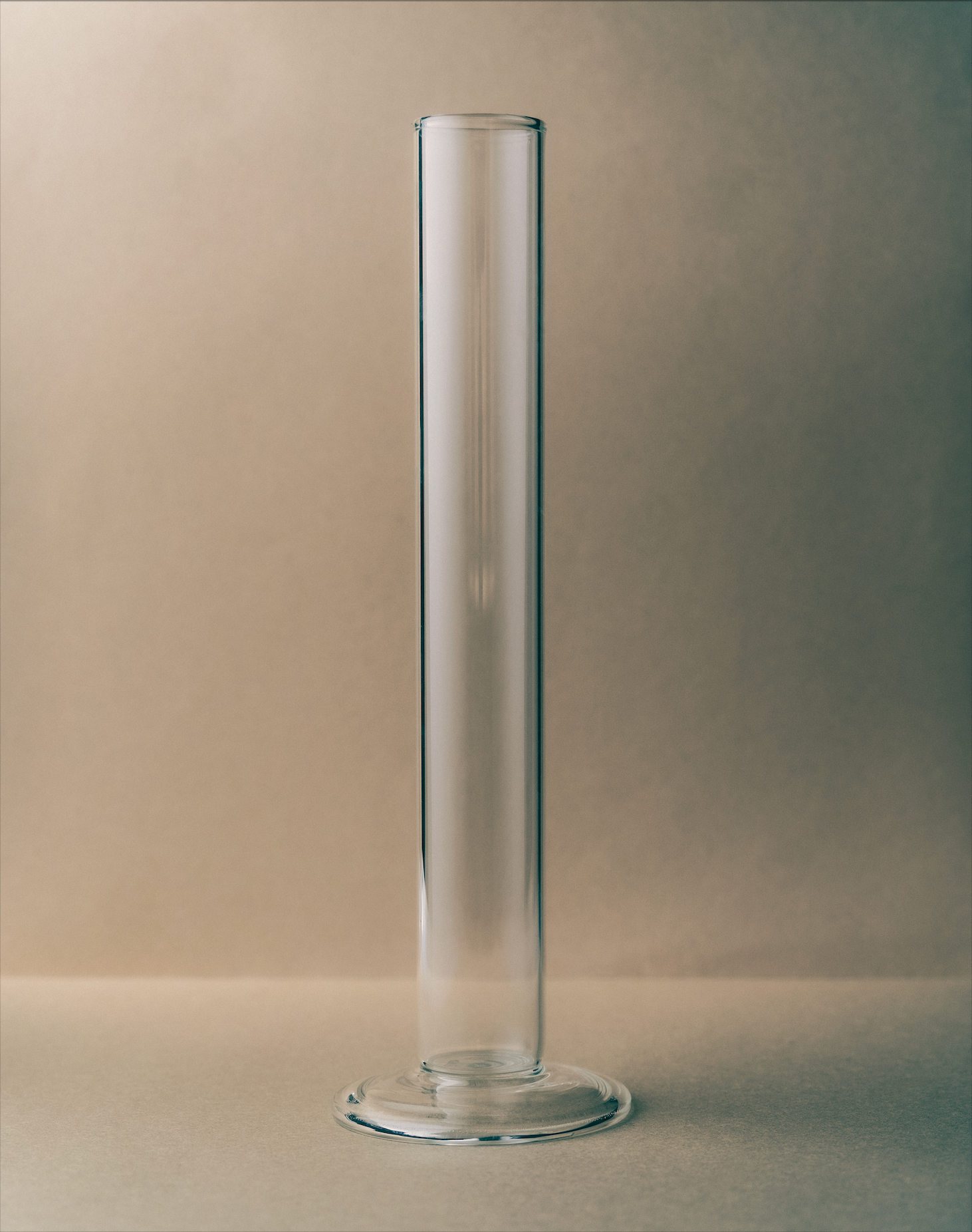 Clear glass vase on a beige background